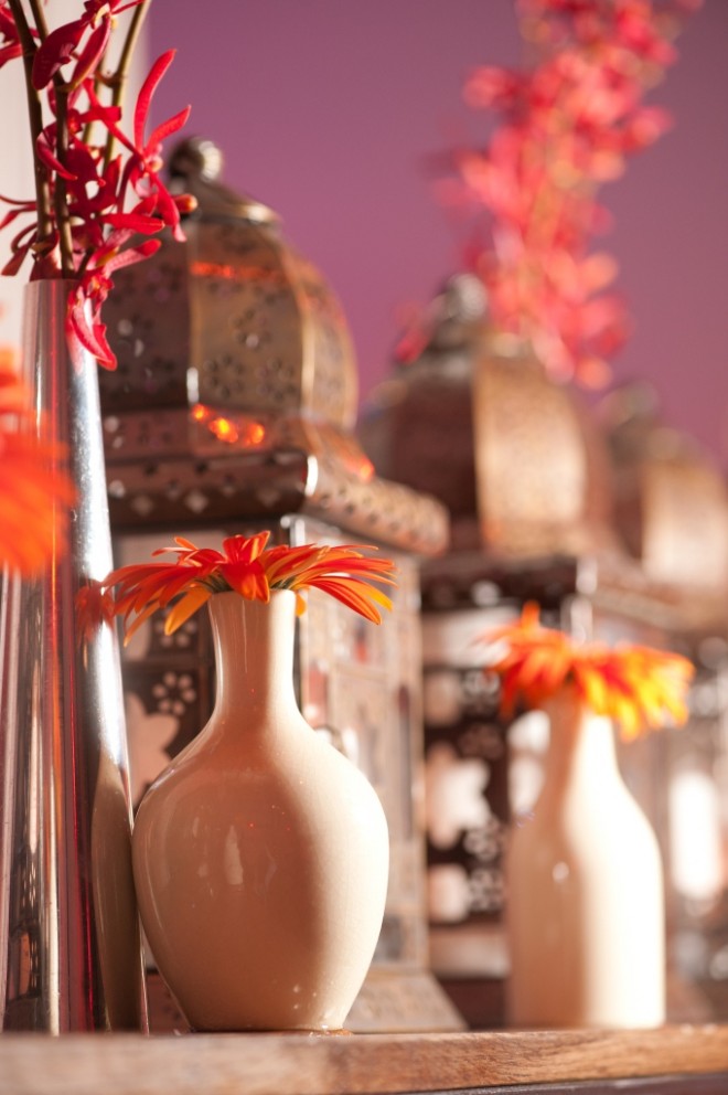 chrome accessories for event design white vases orange gerbera daisies